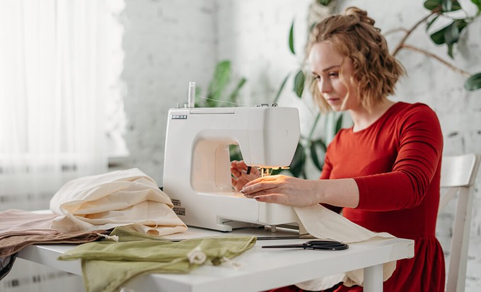 Garment worker sewing to highlight the difference between ethical clothes and what sustainable fashion is