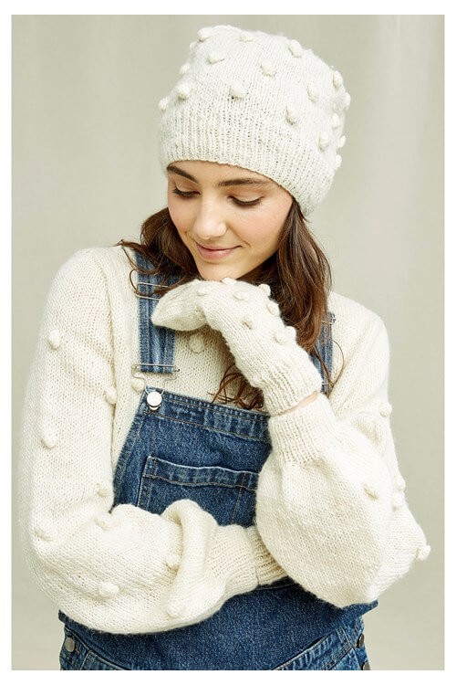 Woman wearing some of the best winter accessories including white mittens