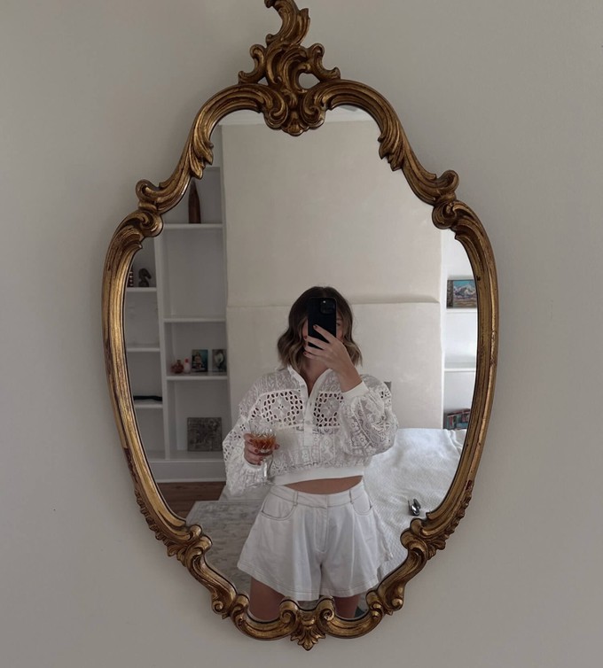 Young person checking their personal style in the mirror